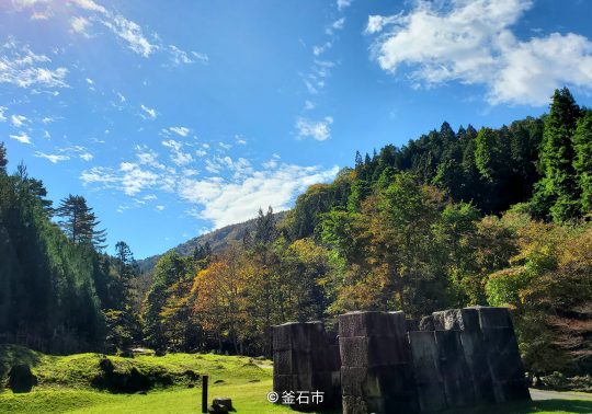 Remains of the blast furnace surrounded by forest at the Hashino Iron Mining and Smelting Site.