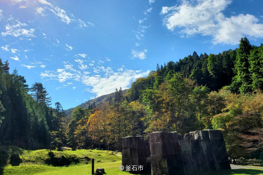 Remains of the blast furnace surrounded by forest at the Hashino Iron Mining and Smelting Site.