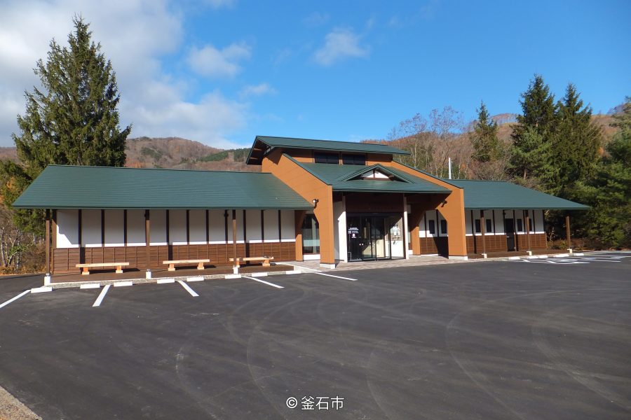 Hashino Iron Mining Information Center building with a parking lot in front.