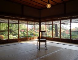 Interior view of a tatami room in the Seienkaku Villa, with wide wooden framed windows overlooking the traditional garden.