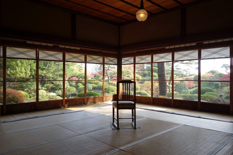 Interior view of a tatami room in the Seienkaku Villa, with wide wooden framed windows overlooking the traditional garden.