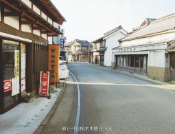 A historic streetscape in Kaeimon-cho with traditional white-walled and dark wood merchant buildings.