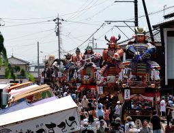 Giant warrior doll floats (dashi) parading through the crowded Mikuni Minato street during the Mikuni Festival.