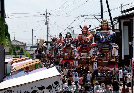 Giant warrior doll floats (dashi) parading through the crowded Mikuni Minato street during the Mikuni Festival.