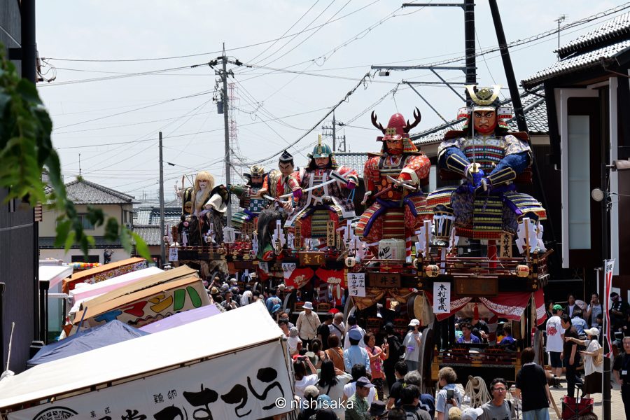 Giant warrior doll floats (dashi) parading through the crowded Mikuni Minato street during the Mikuni Festival.