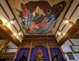 Vibrantly colored ceiling painting of a phoenix by Katsushika Hokusai, possibly at Gansho-in Temple in Obuse, above a Buddhist altar.