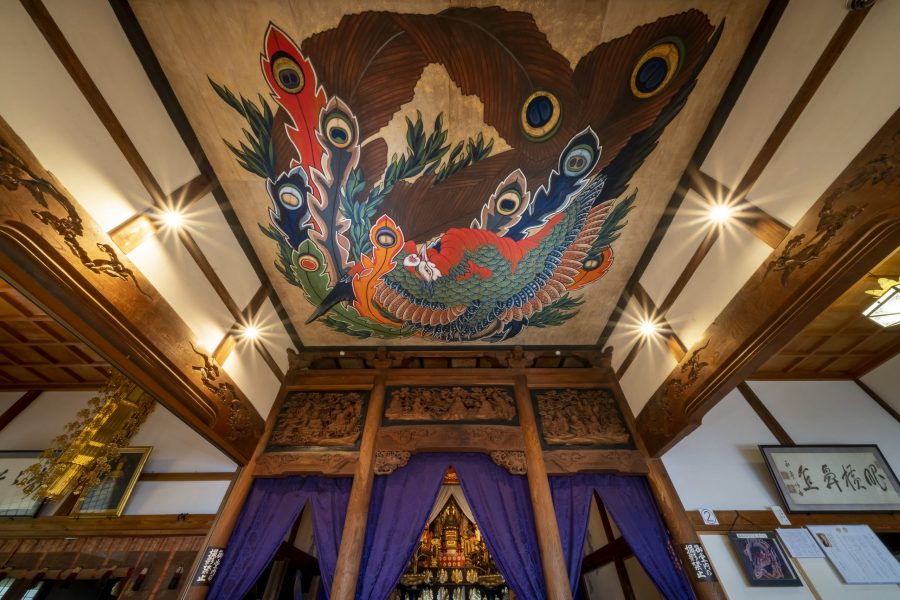 Vibrantly colored ceiling painting of a phoenix by Katsushika Hokusai, possibly at Gansho-in Temple in Obuse, above a Buddhist altar.