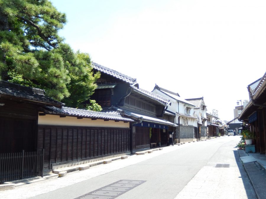 The preserved Edo period townscape of Arimatsu, lined with traditional wooden buildings and black tiled roofs.