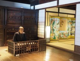Traditional interior of an Edo-period building in Seki-juku, featuring a mannequin and decorative folding screens.