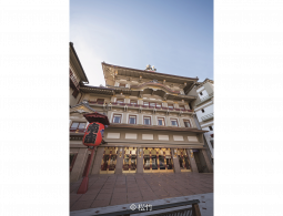 The main facade of the Minamiza Kabuki Theatre, featuring Momoyama-style architecture and a large red lantern (chochin) in the foreground.