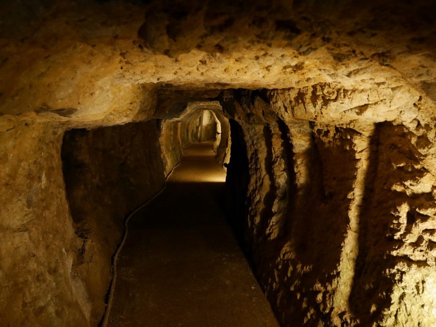 The interior of a dimly lit, hand-dug mine tunnel (mabu) at the Iwami Ginzan Silver Mine.