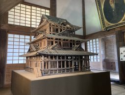 A large, detailed wooden architectural model of the castle keep, displayed in the museum interior.