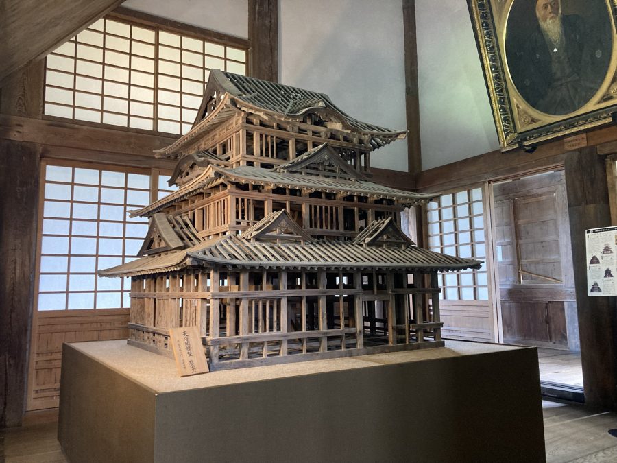 A large, detailed wooden architectural model of the castle keep, displayed in the museum interior.