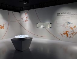 A modern, brightly lit museum exhibit dedicated to the Kakiemon style of porcelain, featuring a small porcelain doll and a plate on a pedestal.