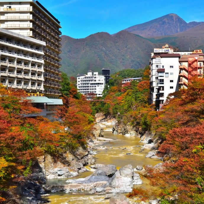 Kinugawa Onsen town view with river and autumn leaves.