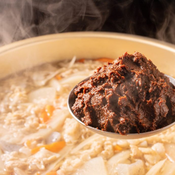 Hatcho miso stew cooking in a clay pot.