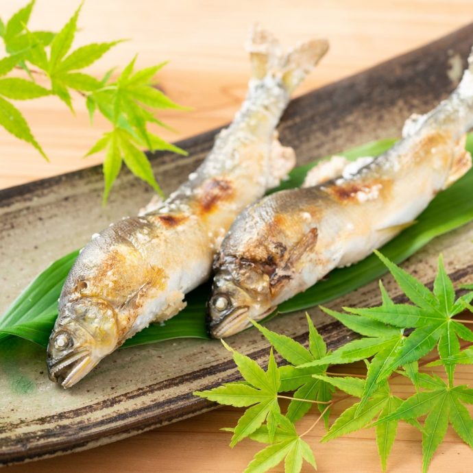 Salt-grilled ayu (sweetfish) on a leaf.