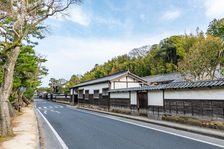 Street with traditional white-walled buildings in Matsue.