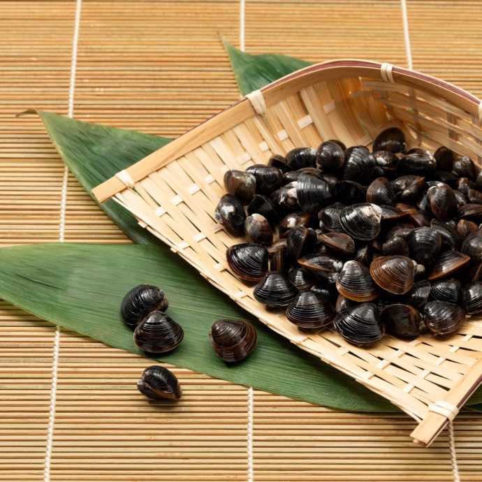 Shijimi (freshwater clams) in a bamboo strainer.