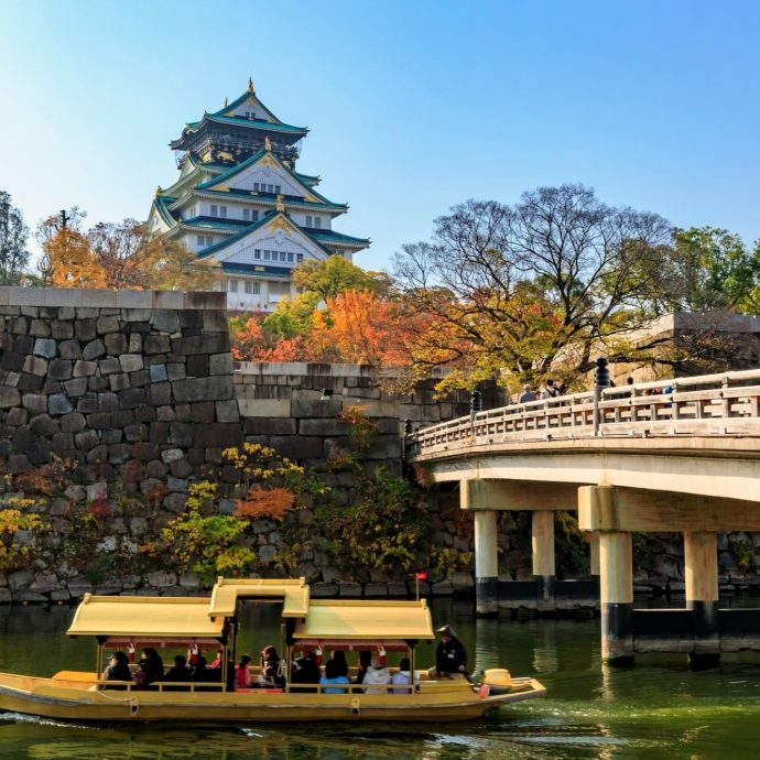 Osaka Castle with a boat on the moat.
