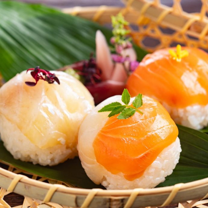 Temari sushi (sushi balls) in a bamboo basket.