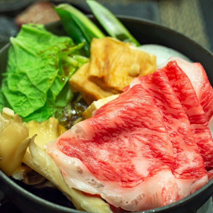 Raw Omi beef slices ready for hot pot.