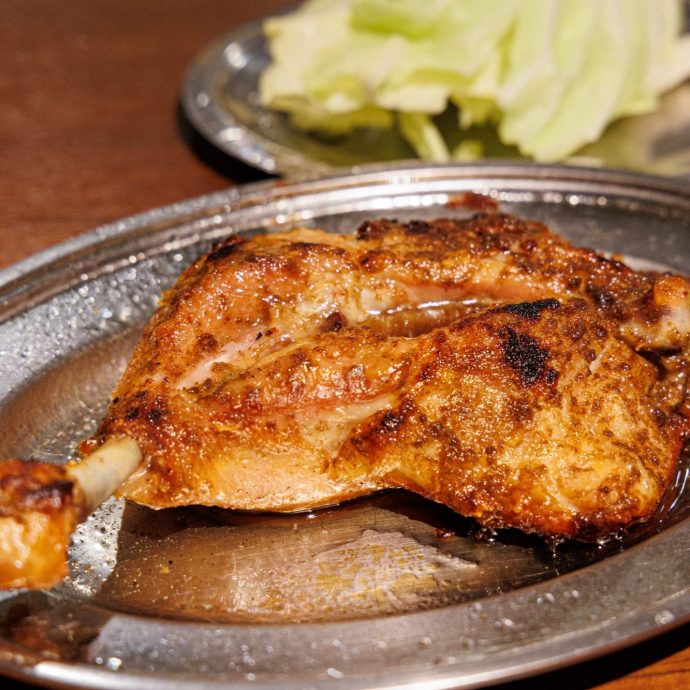 Honetsukidori (grilled chicken on the bone) on a plate.