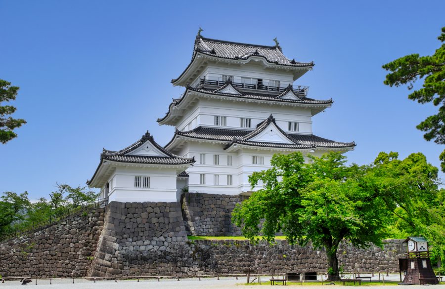 Odawara Castle tower against a blue sky.
