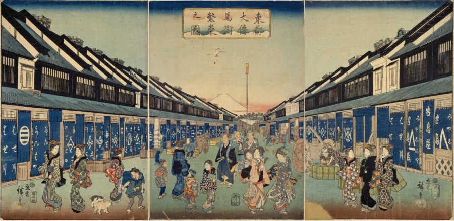 A vibrant three-panel Ukiyo-e woodblock print by Hiroshige depicting a bustling street in Edo's Odenma-cho district, lined with traditional shops with blue curtains and filled with people in kimonos, with Mount Fuji visible in the far distance.