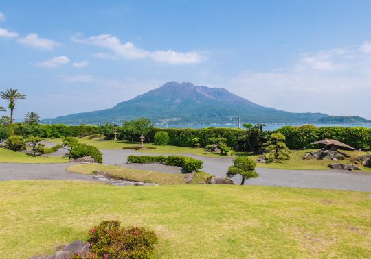 View of Sengan-en Garden featuring the borrowed scenery of Sakurajima volcano in the background.